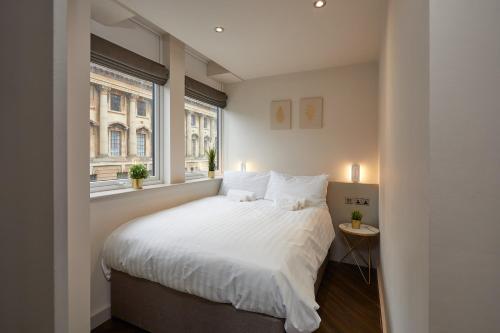 a bedroom with a white bed and a window at Humber Lofts Apartments in Hull