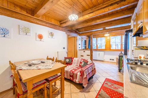 a kitchen and dining room with a table and a dining room at Charming Tabià in Rocca Pietore