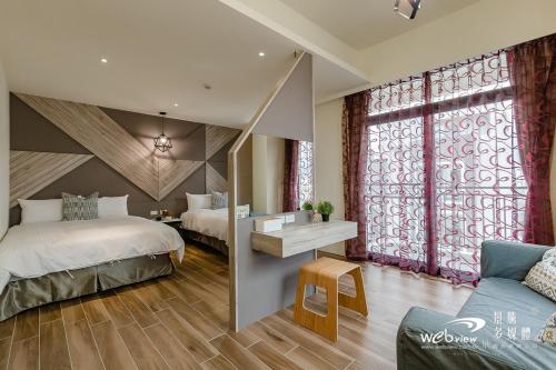 a bedroom with two beds and a large window at Xiao Tian Di Homestay in Taitung City