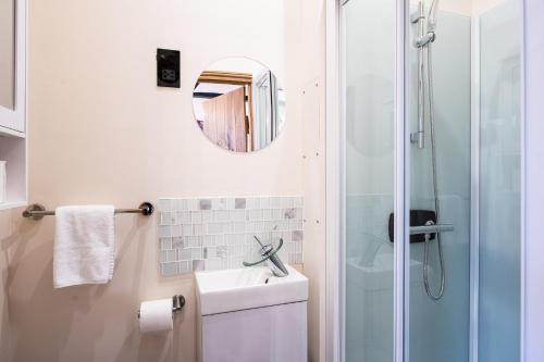 a bathroom with a shower and a sink and a mirror at Eakley Stables 1 - Woody 