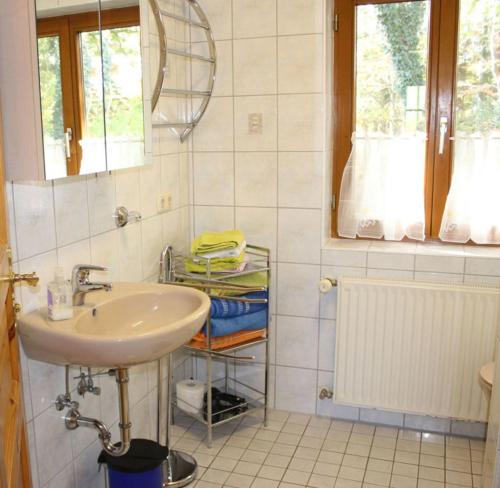 a bathroom with a sink and a mirror at Ferienwohnung Herold in Wessobrunn