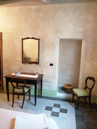 a room with a table and a mirror and a chair at 44 - Mu Ni in Amelia