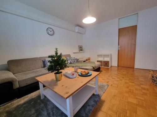 a living room with a table with a christmas tree on it at Apartment Gulek in Zreče