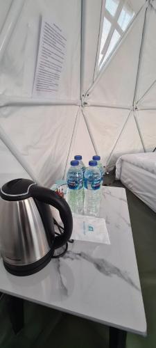 a table with two bottles of water on it at ข้างเขาแคมป์ Khangkhao Camp in Ban Yang Khun Wang