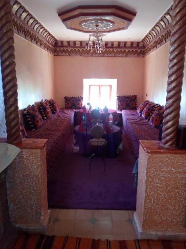 a room with rows of tables and a chandelier at Gte Tawada - Happy Valley - Room for 3 People in Agouti