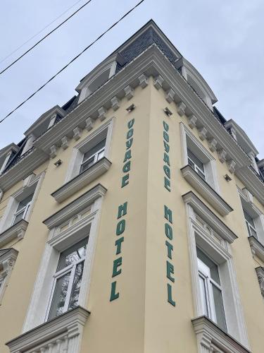 a building with a sign on the side of it at Voyage in Odesa