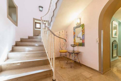 a staircase in a home with a mirror and a table at Villa Fantasia Budget Boutique Hotel in Füssen