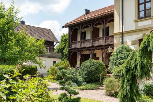 a house with a garden in front of it at Villa Fantasia Budget Boutique Hotel in Füssen