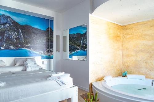 uma casa de banho com uma banheira e uma cama e uma banheira em Sunshine Charming Houses em Alghero