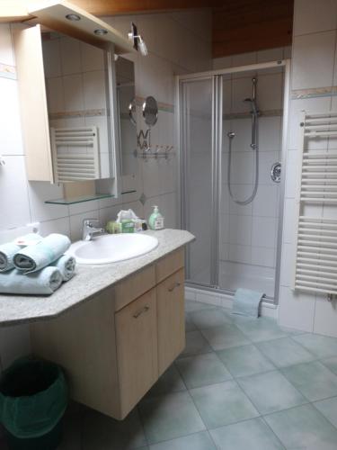 a bathroom with a sink and a shower at Haus Kristall in Alpbach