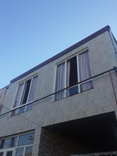 a building with windows on the side of it at Guesthouse Qeti in Batumi