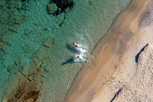 an aerial view of a person swimming in the ocean at Villa Alyko in Aliko Beach