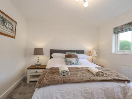 a bedroom with a large bed and a window at Woodview in Pooley Bridge