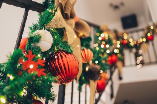 a row of christmas decorations on a railing at 1oak villa in Vir