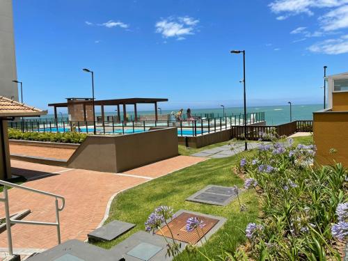 a patio with a view of the beach and the ocean at BarraVilha Resort Vista Mar e Pé na Areia in Barra Velha
