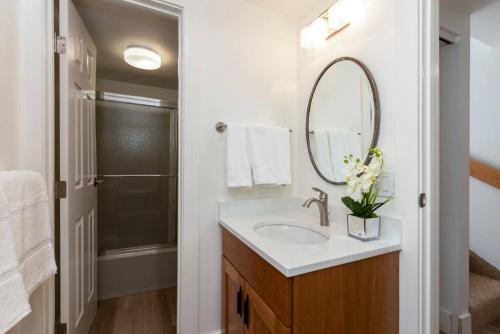 a bathroom with a sink and a mirror at Updated 3 BR, 2 BA with Pool & Hot Tub - Stunning Mountain Views! in Snowmass Village