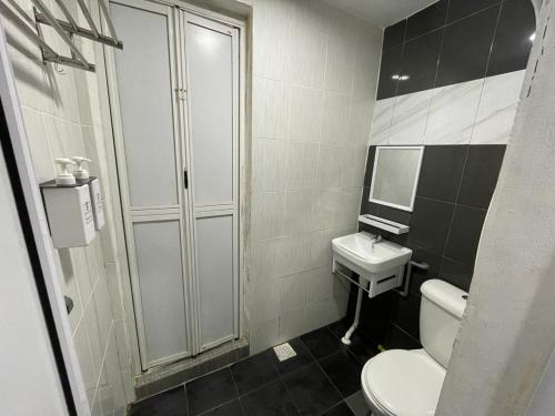 a bathroom with a toilet and a sink at The Sky Inn in Kuantan