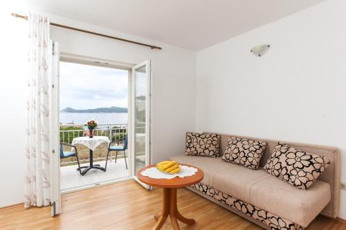 a living room with a couch and a table at Apartments Ana in Lopud