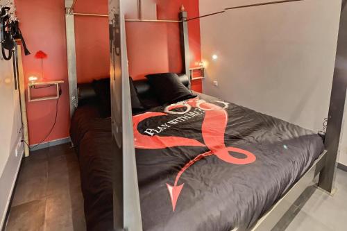 a bunk bed with a red ribbon on it at LE DONJON Villa BDSM Port Nature VILLAGE Cap d'Agde naturiste in Cap d'Agde