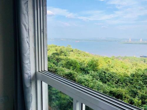 a view of the ocean from a window at lovely 2-bedroom sea view serviced apartment dabolim goa in Dabolim