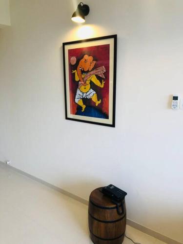 a picture on a wall next to a wooden barrel at lovely 2-bedroom sea view serviced apartment dabolim goa in Dabolim
