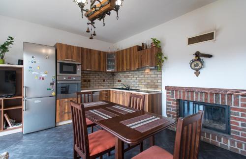 a kitchen with a table and a refrigerator at Ubytování Světluška in Třeboň