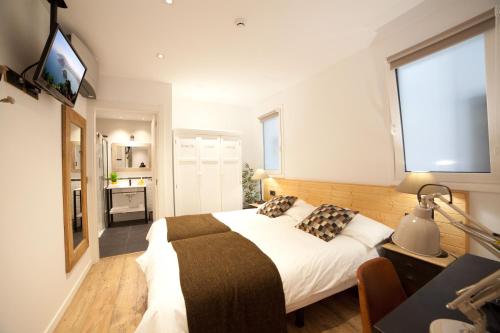 a bedroom with a large bed and a window at Casa Nicolasa in Donostia-San Sebastián
