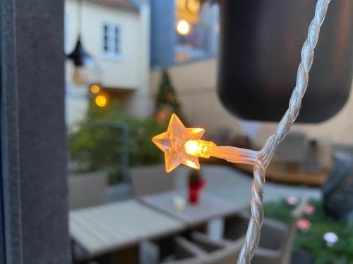 a star on a piece of rope with a table at Hotel Aarhus City Apartments in Aarhus