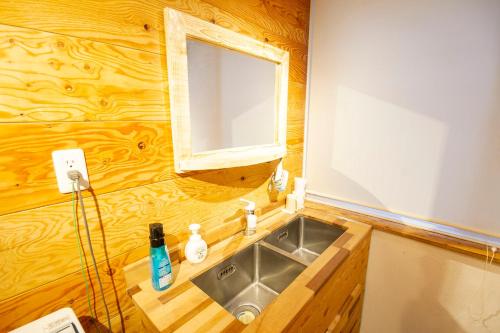 a bathroom with a sink and a mirror at kODATEL コダテル 札幌大通公園 101 in Sapporo