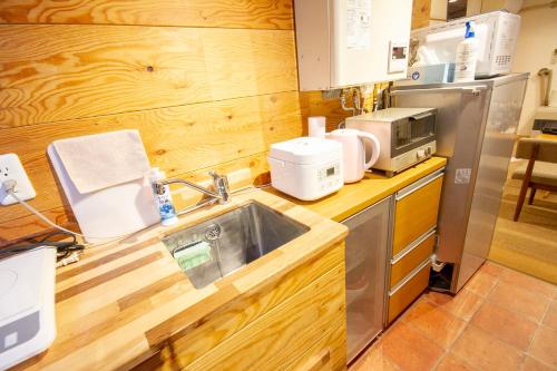 a kitchen with a sink and a microwave at kODATEL コダテル 札幌大通公園 101 in Sapporo