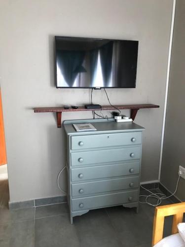 a dresser with a television on top of it at SelkieBnB in Walvis Bay