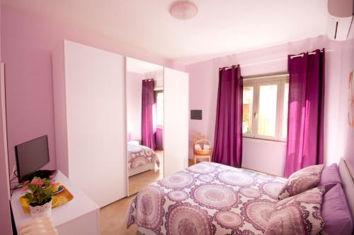 a bedroom with purple curtains and a bed at Sophie's Choice in Rome