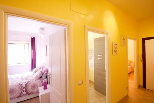 a yellow room with a bed and a window at Sophie's Choice in Rome