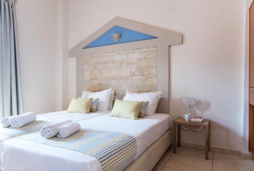 a bedroom with a large bed with a blue ceiling at Ilios 1 Central in Malia