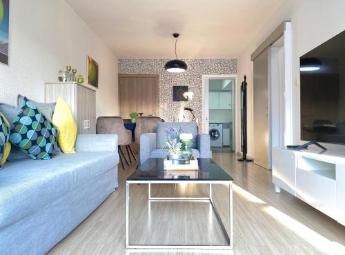a living room with a couch and a table at Metro Court Apartments in Limassol
