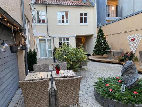 an outdoor patio with a table and a christmas tree at Hotel Aarhus City Apartments in Aarhus