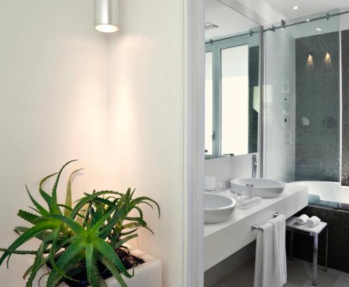 a bathroom with two sinks and a potted plant at LHP Hotel Santa Margherita Palace & SPA in Santa Margherita Ligure