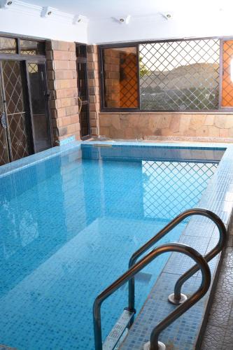 a swimming pool with a bench in front of it at ASWAN NILE PALACE (swimming pool-rooftop-Nile view) in Aswan