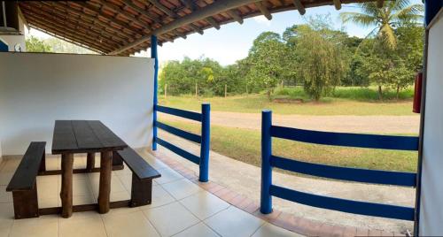 a wooden bench sitting next to a fence at Tijota Hotel Fazenda in Ipatinga
