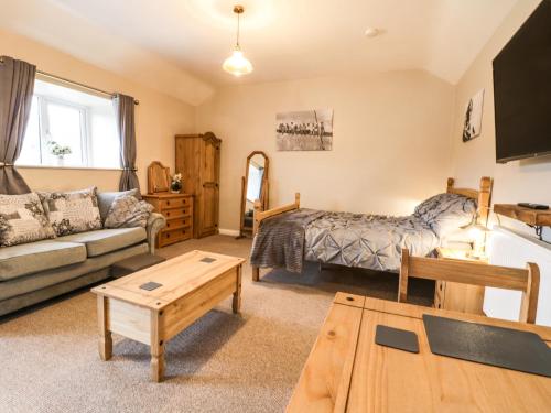 a living room with a couch and a table at Forest View Cottage in Scarborough