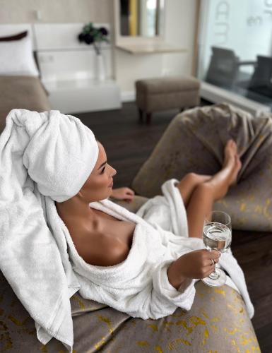a naked woman laying on a couch with a towel at sky FLAT jacuzzi sauna 27 FLOOR in Klaipėda