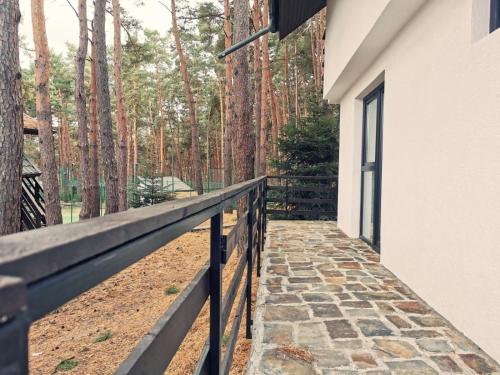 a walkway to a house with trees in the background at Complex Parc Pini Moinesti in Moineşti