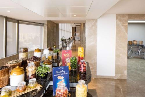 a lobby with a table full of food items at Radisson Blu Mumbai International Airport in Mumbai