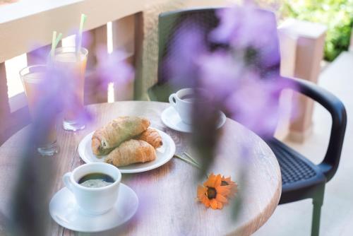 a table with two plates of food and a cup of coffee at Le Palme in Malia