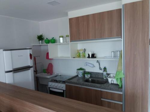 eine kleine Küche mit Spüle und Kühlschrank in der Unterkunft Apartamentos Brisa del Mar in Luis Correia