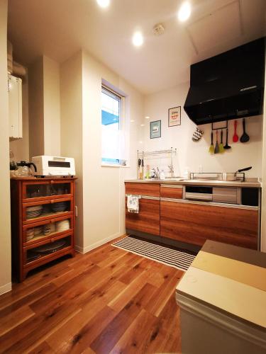 a kitchen with wooden floors and a counter top at Opopo home 堺町店 in Otaru