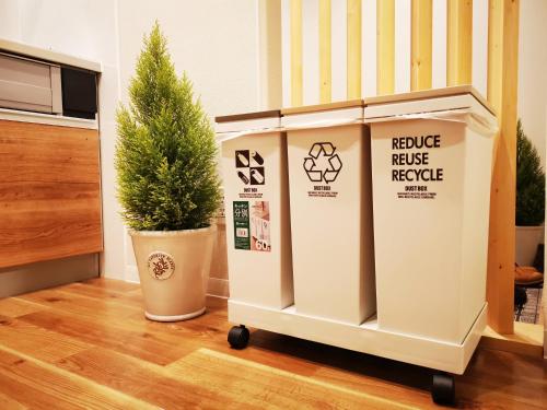 a couple of boxes sitting next to a potted tree at Opopo home 堺町店 in Otaru