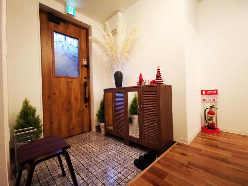 a room with a door and a table and a chair at Opopo home 堺町店 in Otaru