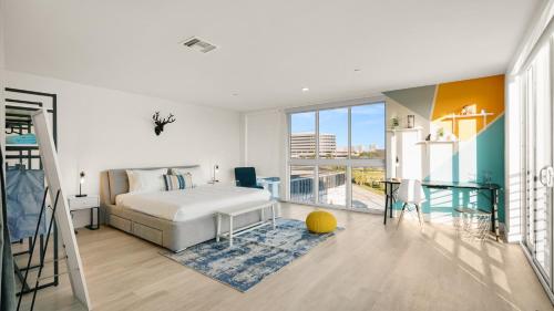 a bedroom with a bed and a balcony at Lofts of Aventura in Miami