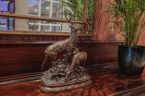 a statue of a giraffe on a table at Dunadry Hotel And Gardens in Antrim